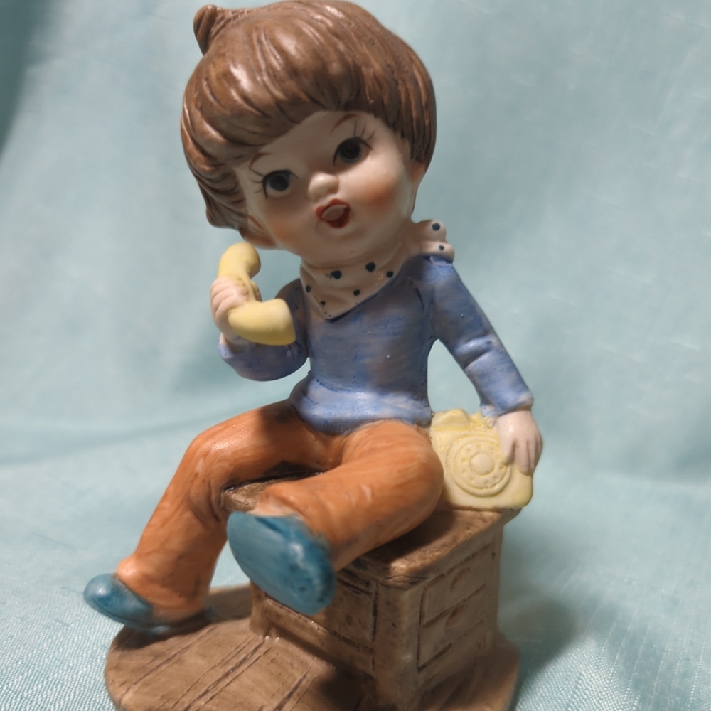 Vintage porcelain figurine girl talking on the phone. Housekeepers Series